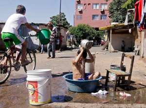 A boy bathes in a laundry basin in the Chacarita slum of Asuncion